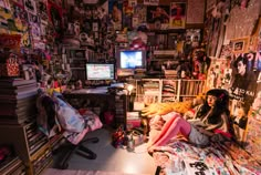 a woman sitting on top of a bed in a room filled with books and magazines