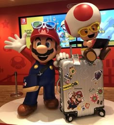 mario and luigi are standing next to each other in front of a nintendo game display