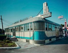 an old diner sits on the corner of a street