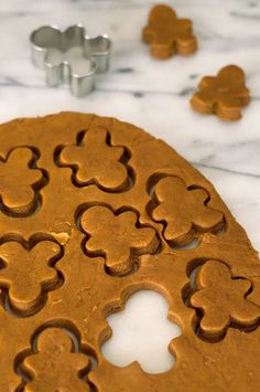 a cookie that has been cut into smaller shapes and is sitting on a table next to some cookies cutters