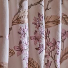 the curtains are decorated with pink flowers and leaves