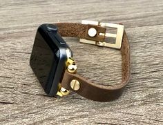 High Quality Slim Brown Color Leather Strap with Gold Accents. Women Style Classy Strap with Adjustable Buckle. Gorgeous Design Bracelet Tailored to Perfection. Designed And Handmade by Simeon D Jewelry Studio. This Bracelet Fits ALL Apple Watch Series. Please Measure Your Wrist Before Submitting Your Order! Not For Other Models. Apple Watch Is NOT Included. Let's be Friends! Follow my Studio on Social Media Instagram @simeondjewelry Pinterest @simeondjewelry Facebook @simeondjewelrystudio Apple Watch Bracelet, Apple Watch Bracelets, Tech Jewelry, Leather Apple Watch Band, Gold Apple Watch, Gold Apple, Design Bracelet, Apple Watch Bands Leather, Apple Watch 38mm