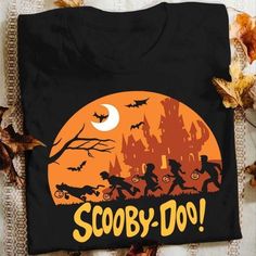 Scooby Doo Halloween T Shirt Hoodie Sweater available in T-shirt, hoodie, tank top, longsleeve, multi color and size S M L XL XXL 3XL 4XL 5XL. Shipping from the US. Easy 30 day return policy - Shop now! 6.1-ounce, 100% cotton .Double-needle neck, sleeves and hem; Roomy Unisex Fit. Ash is 99% cotton, 1% poly; Sport Grey is 90% cotton, 10% poly; Dark Heather is 50% cotton, 50% polyester .Decoration type: Digital Print. Made by Gildan Scoobydoo Shirt, Halloween Scooby Doo, Scooby Doo Shirt, Scooby Doo Halloween, Sweater Oversize, Halloween Fashion, Halloween T Shirt, Hoodie Sweater, Halloween Tshirts