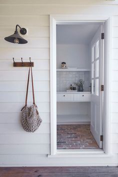 an open door with a purse hanging from it's side and a hook on the wall