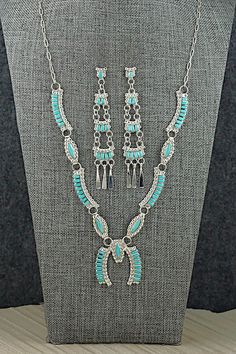 This intricately crafted turquoise and sterling silver necklace and earrings set was made by Zuni silversmith Lucy Sheeyka. The back of the pendant is signed LS and Zuni.Necklace: 22"Pendant:Length: 1 3/8"Width: 1 1/4"Earrings:Length: 3 1/8"Width: 5/8"Free shipping on all orders! We ship with USPS and always include tracking. All orders ship within a day of payment.Returns are accepted up to 30 days after you receive your order. Just send us a message. Our shop offers cash back or store credit. 4 Earrings, Necklace And Earrings Set, Necklace And Earrings, Sterling Silver Necklace, Turquoise Sterling Silver, Earrings Set, Sterling Silver Necklaces, Earring Set, Jewelry Sets