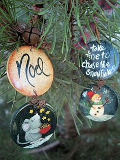 ornaments hanging from a christmas tree decorated with magnets and handwritten words, including mice to chase the snowflakes