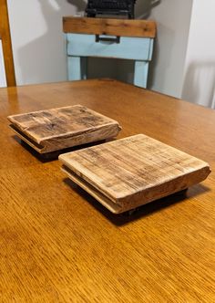 two wooden coasters sitting on top of a wooden table