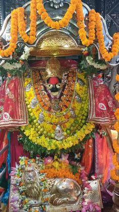 the idol is adorned with flowers and garlands