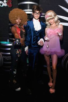 three people in costumes standing next to each other