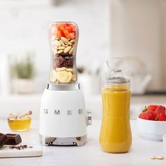 a blender filled with fruit and nuts on top of a counter