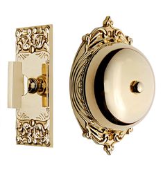 an ornately designed door handle and knob on a white background, with gold accents