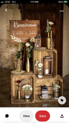 a wooden crate with flowers and candles on it sitting in front of a sign that reads bierene ete de jolie