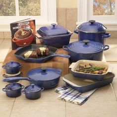 the blue pots and pans are on the table