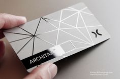 a person holding up a metal card with the word archita on it and an arrow