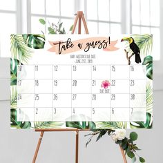 a calendar with tropical leaves on it and a bird sitting on top of the calendar