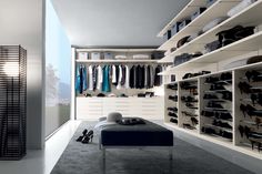 a walk in closet filled with lots of shoes next to a wall mounted shoe rack