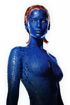 a woman with blue paint on her body and orange hair is posing for the camera