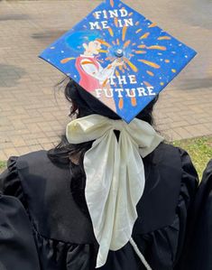 a person wearing a graduation cap with the words find me in the future on it