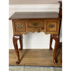 an old wooden table with two drawers on one side and a drawer on the other