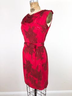 "1960s tonal red printed mini dress has an all over glitter dot print, cowl neck, and matching bow belt that fastens in the front with snaps. The dress is fully lined and has a back metal zipper. Condition Overall excellent - some of the glitter has rubbed off throughout, and there's a small hole at the left front waist. Measurements Bust 36\" Waist 27\" Shoulder 17.5\" Hip 38\" Length 35\"" Bow Belt, Crochet Shrug, Glitter Print, Strapless Gown, Rayon Dress, Floral Scarf, Red Silk, Metal Zipper, Printed Mini Dress