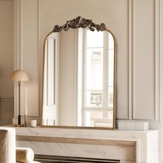 a mirror sitting on top of a fireplace in a living room