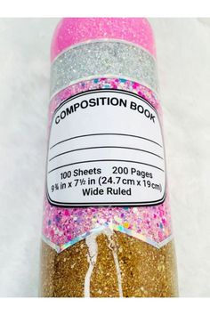 a close up of a bottle of confetti colored glitter on a white background