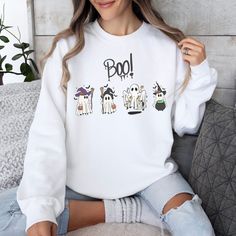 This Halloween, get ready to show off your spooky vibes with this groovy ghost-themed sweatshirt! Featuring cute ghosts, witches, and other spooky characters, this sweatshirt is perfect for the spooky season. The bright colors and fun designs will make you look cute and stylish while still embracing the spirit of Halloween. Trick or treat in style with this spooky ghost-themed sweatshirt! The perfect way to show off your love of all things spooky, creepy, and boo-tiful. Get ready to have a happy Trendy Fall Hoodie With Character Print, Fun Long Sleeve Sweatshirt With Character Print, Trendy White Halloween Hoodie, White Cartoon Print Sweater For Fall, Trendy Fall Sweatshirt With Character Print, White Character Print Hoodie For Fall, Trendy Character Print Sweatshirt For Fall, Cute White Fall Sweatshirt, Cute White Sweatshirt For Fall