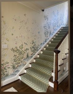 the stairs are decorated with floral wallpaper