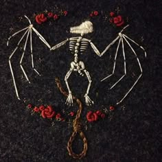 a skeleton is laying on the ground with roses around it