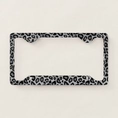 a black and white license plate frame with an animal print pattern on the bottom half