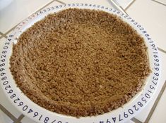 a cake sitting on top of a white plate covered in brown crumbled sugar