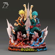 two anime figurines are posed on top of each other with their arms in the air