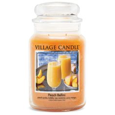 a candle with peach bellini in it on a white background and the words village candle