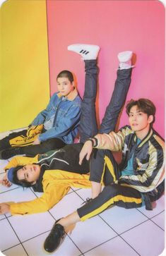 three boys laying on the floor with their feet up