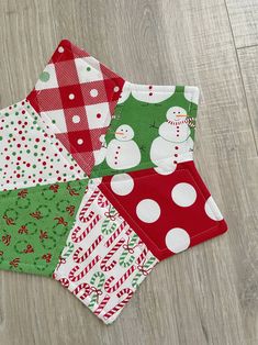 four christmas napkins on a wood floor