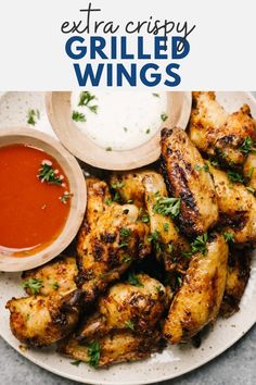 grilled wings on a plate with dipping sauce and garnishes to the side