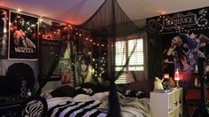 a bedroom decorated for halloween with posters and lights