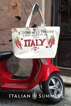 a red scooter with a tote bag on it