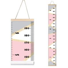 a pink and grey growth chart hanging on a wall next to a ruler with numbers