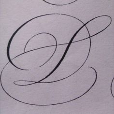 the letter e is drawn with black ink on white paper, and it appears to be in cursive writing