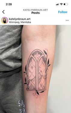 a person with a tattoo on their arm that has an image of a window in it