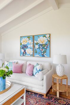 a living room with two paintings on the wall