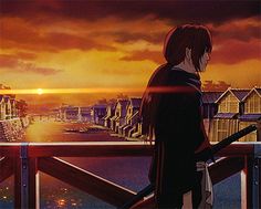 a man standing on top of a balcony next to a sunset