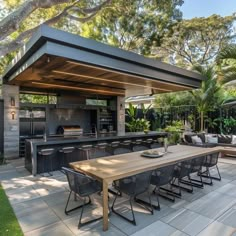 an outdoor kitchen and dining area is shown