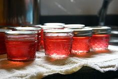 several jars filled with liquid sitting on top of a towel