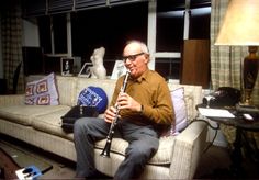 a man sitting on a couch holding a flute