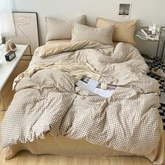 an unmade bed sitting on top of a wooden floor