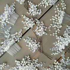 several bridal hair combs with pearls and leaves on wooden background, closeup