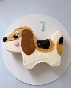 a cake shaped like a dog on top of a white plate