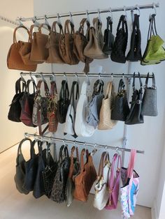 a rack filled with lots of purses hanging from it's sides and on top of each other